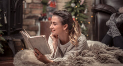 Woman reading a book in a cozy home Christmas atmosphere