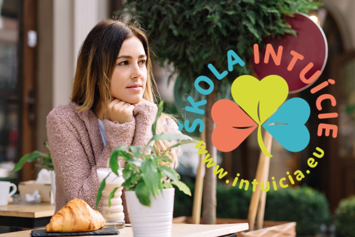 Woman sitting thoughtfully at an outdoor café with coffee and croissant, looking to the side, with the ŠKOLA INTUÍCIE® logo overlaid on the image., Source: https://www.freepik.com/free-photo/pretty-woman-is-sitting-cafeteria-dressed-warm-sweater-waiting-someone-she-is-looking-aside-she-warms-herself-with-warm-drink-autumn-day-portrait-outside-meeting_12965060.htm