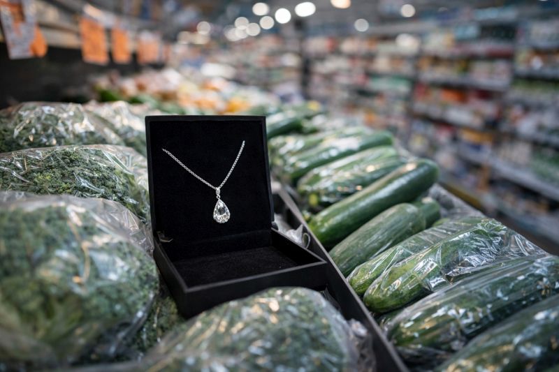 Silver necklace displayed in a grocery store among vegetables, illustrating poor product positioning.