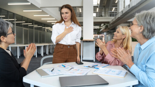 Woman introducing herself to colleagues during her first business meeting in a modern office; Source: https://www.magnific.com/free-photo/middle-aged-hispanic-business-people_150838439.htm