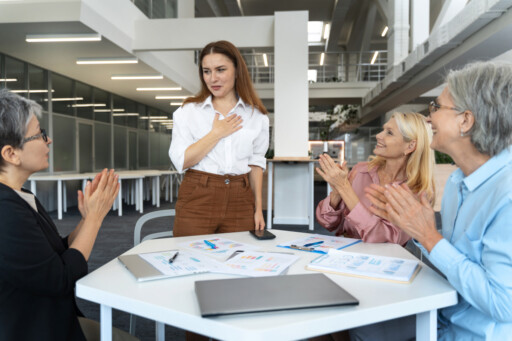 Woman introducing herself to colleagues during her first business meeting in a modern office; Source: https://www.magnific.com/free-photo/middle-aged-hispanic-business-people_150838439.htm