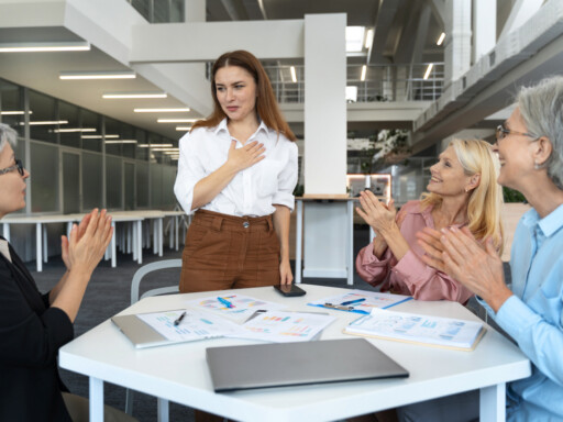 Woman introducing herself to colleagues during her first business meeting in a modern office; Source: https://www.magnific.com/free-photo/middle-aged-hispanic-business-people_150838439.htm