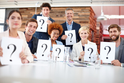 Diverse group of professionals holding question mark signs during a business model quiz. Source: https://www.magnific.com/premium-photo/question-mark-corporate-people-meeting-with-card-input-feedback-market-research-opinion-team-focus-group-workplace-with-paper-decision-employee-test-consumer-growth_423375972.htm