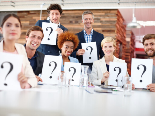 Diverse group of professionals holding question mark signs during a business model quiz. Source: https://www.magnific.com/premium-photo/question-mark-corporate-people-meeting-with-card-input-feedback-market-research-opinion-team-focus-group-workplace-with-paper-decision-employee-test-consumer-growth_423375972.htm